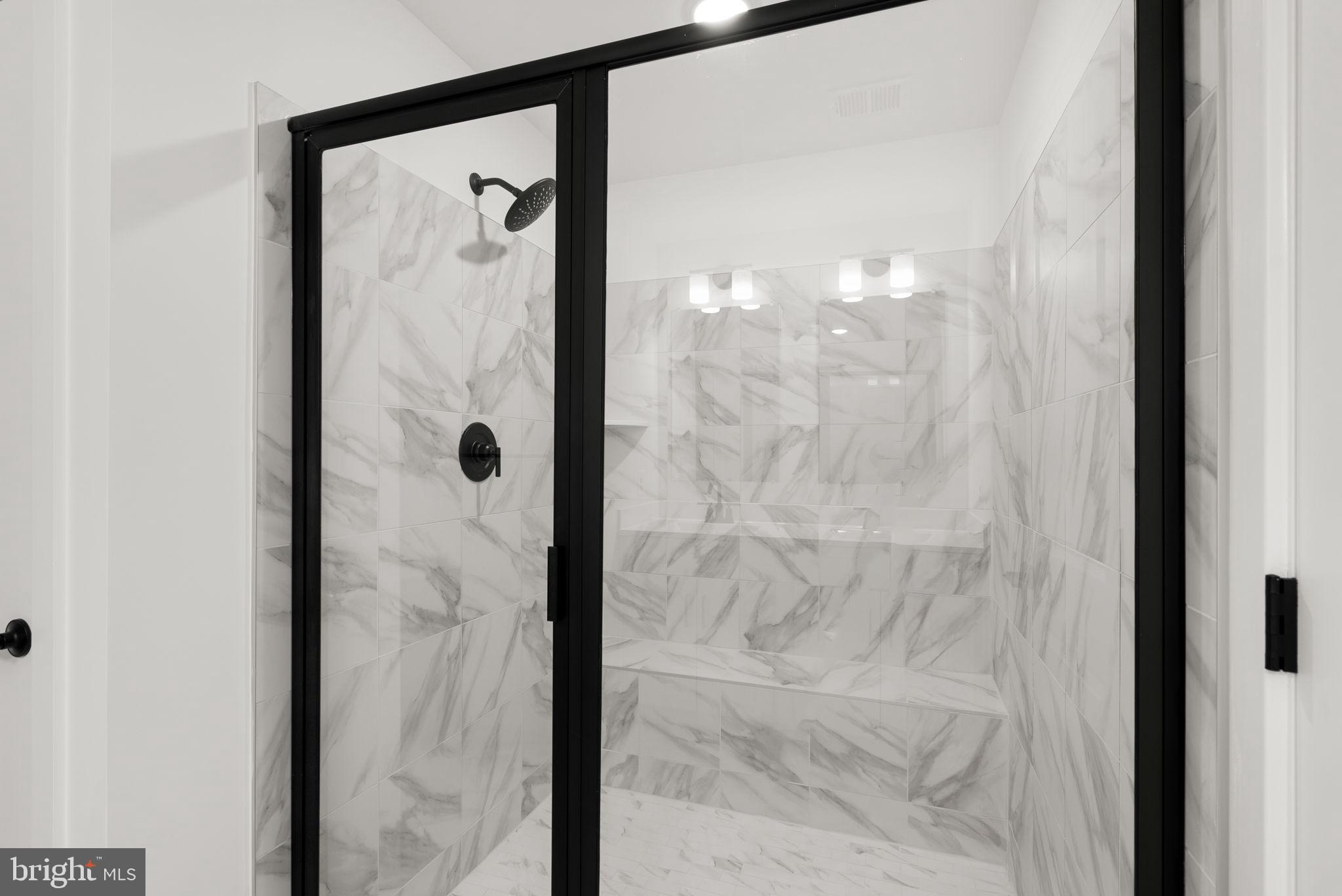 1631 Blacksmith Way, Unit 214B Frederick, MD 21702 - Photo 25 of 41 a bathroom with a glass shower door