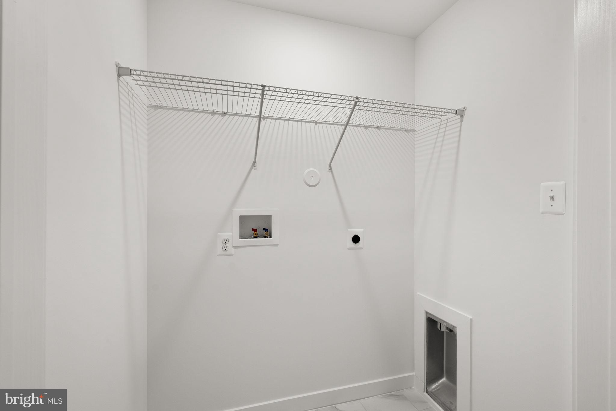 1631 Blacksmith Way, Unit 214B Frederick, MD 21702 - Photo 28 of 41 a bathroom with a shower curtain and a window