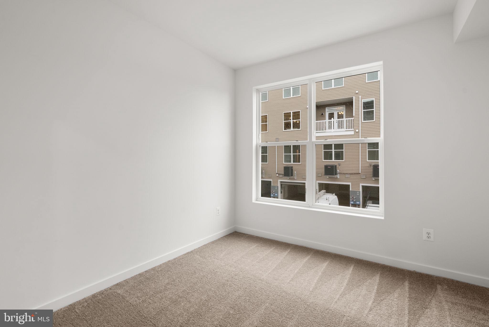 1631 Blacksmith Way, Unit 214B Frederick, MD 21702 - Photo 29 of 41 a view of an empty room with a window