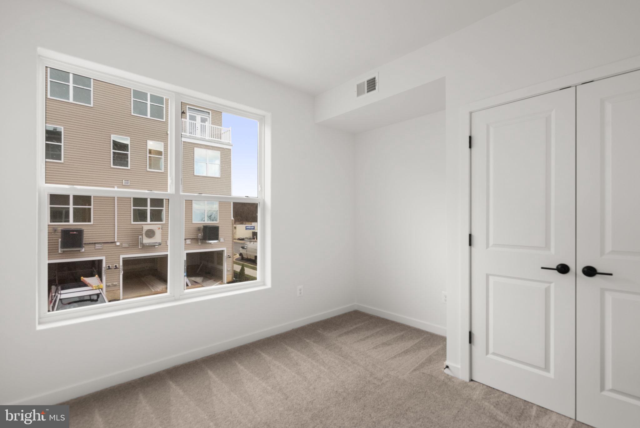 1631 Blacksmith Way, Unit 214B Frederick, MD 21702 - Photo 30 of 41 a view of an empty room with a window