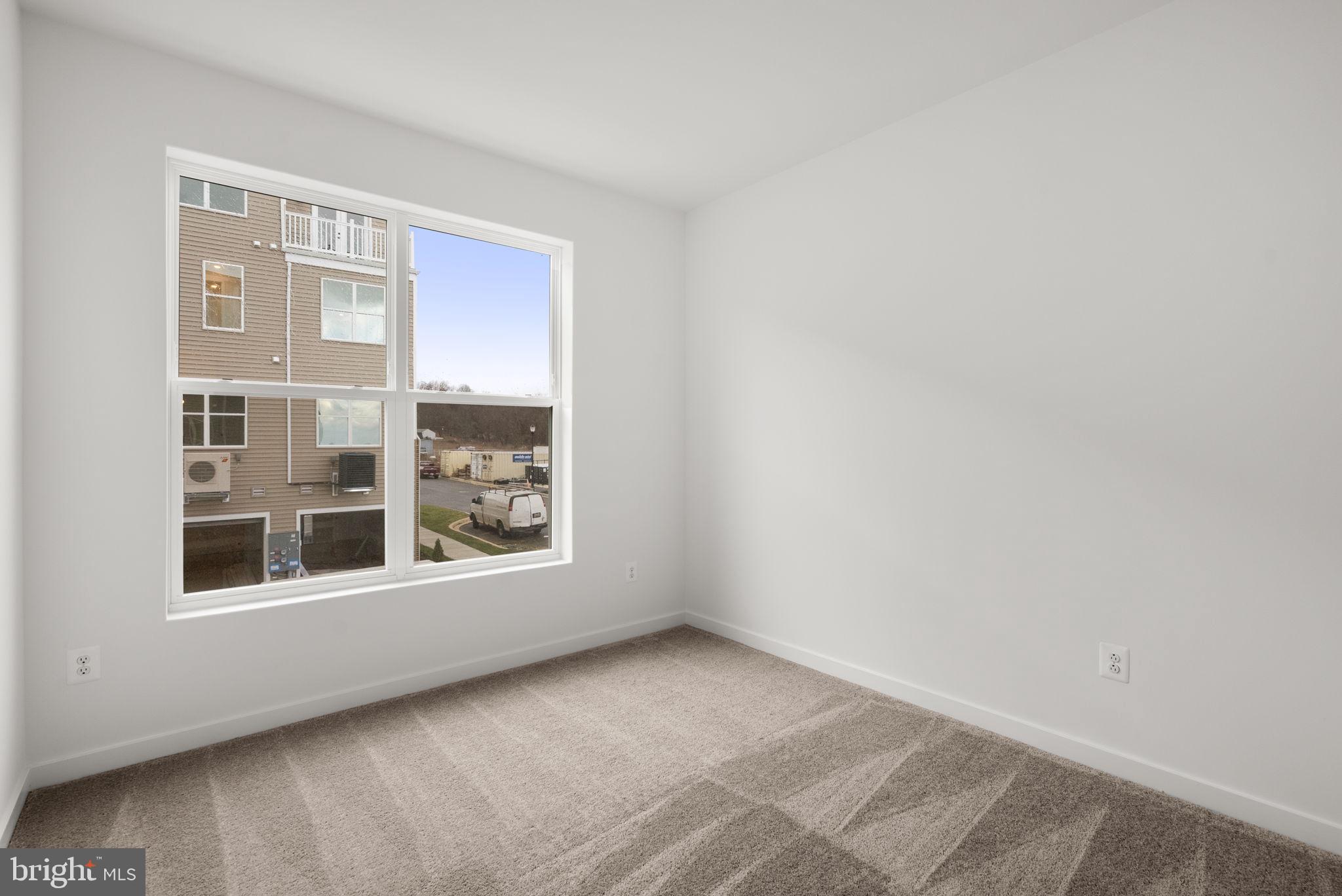 1631 Blacksmith Way, Unit 214B Frederick, MD 21702 - Photo 32 of 41 a view of an empty room with a window