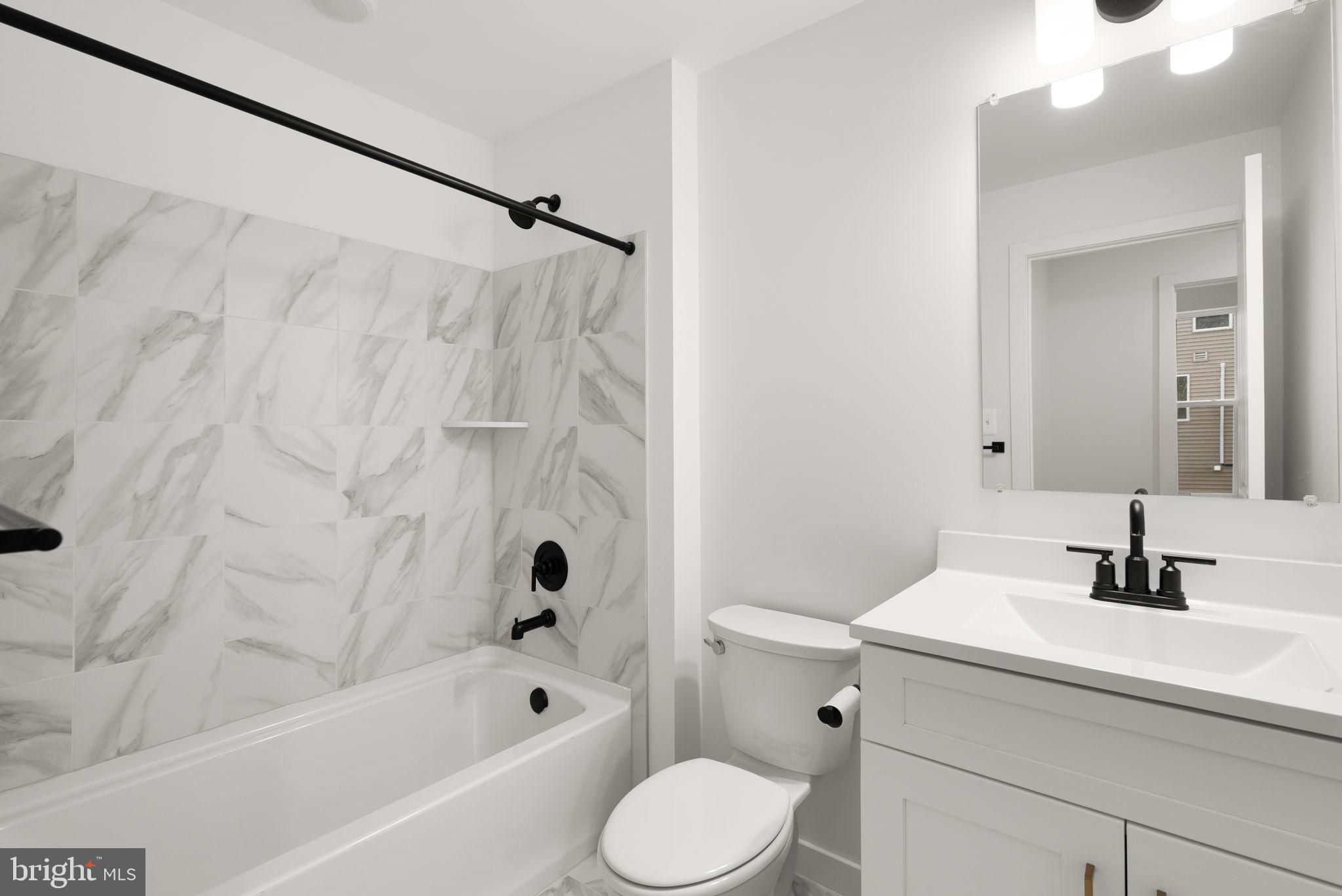 1631 Blacksmith Way, Unit 214B Frederick, MD 21702 - Photo 34 of 41 a bathroom with a sink toilet and shower