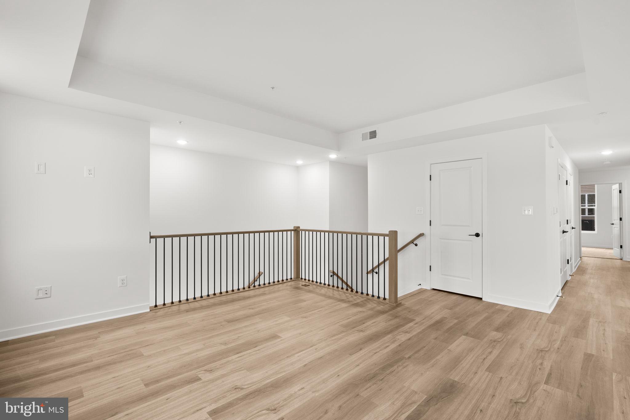 1631 Blacksmith Way, Unit 214B Frederick, MD 21702 - Photo 7 of 41 a view of a room with wooden floor