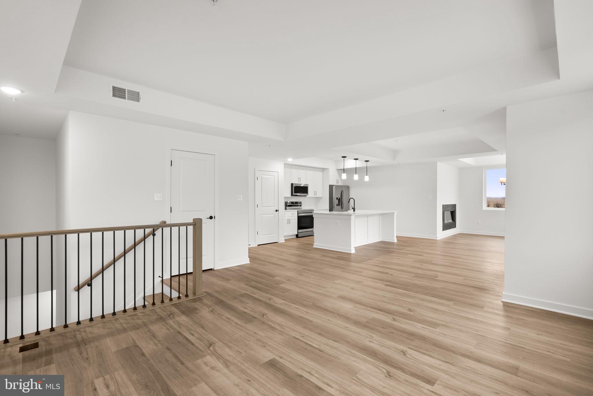1631 Blacksmith Way, Unit 214B Frederick, MD 21702 - Photo 8 of 41 a view of empty room with wooden floor