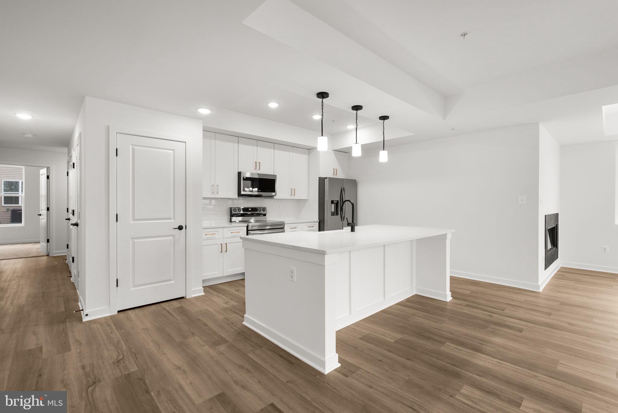 1631 Blacksmith Way, Unit 214B Frederick, MD 21702 - Photo 9 of 41 a view of kitchen with stainless steel appliances refrigerator stove microwave and cabinets