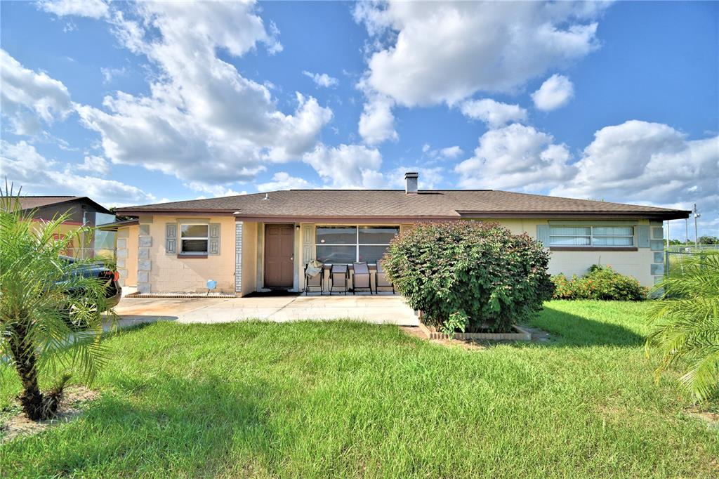 31 Attucks Circle Frostproof, FL 33843 - Photo 1 of 17 a front view of a house with a garden and plants