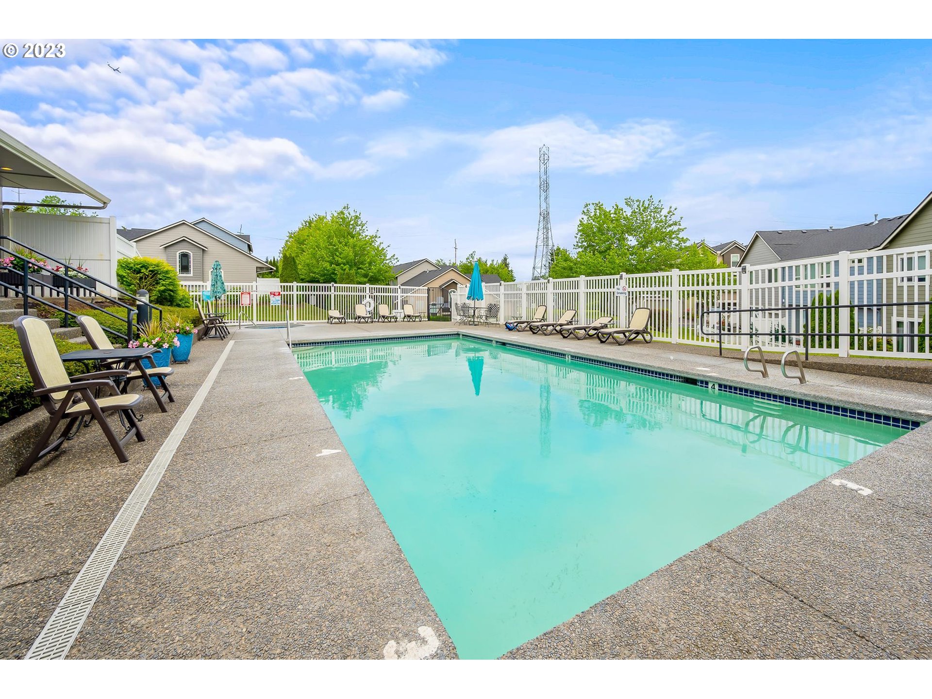 2830 Northeast Blossom Hill Road Fairview, OR 97024 - Photo 23 of 34 a view of a swimming pool with a lounge chairs