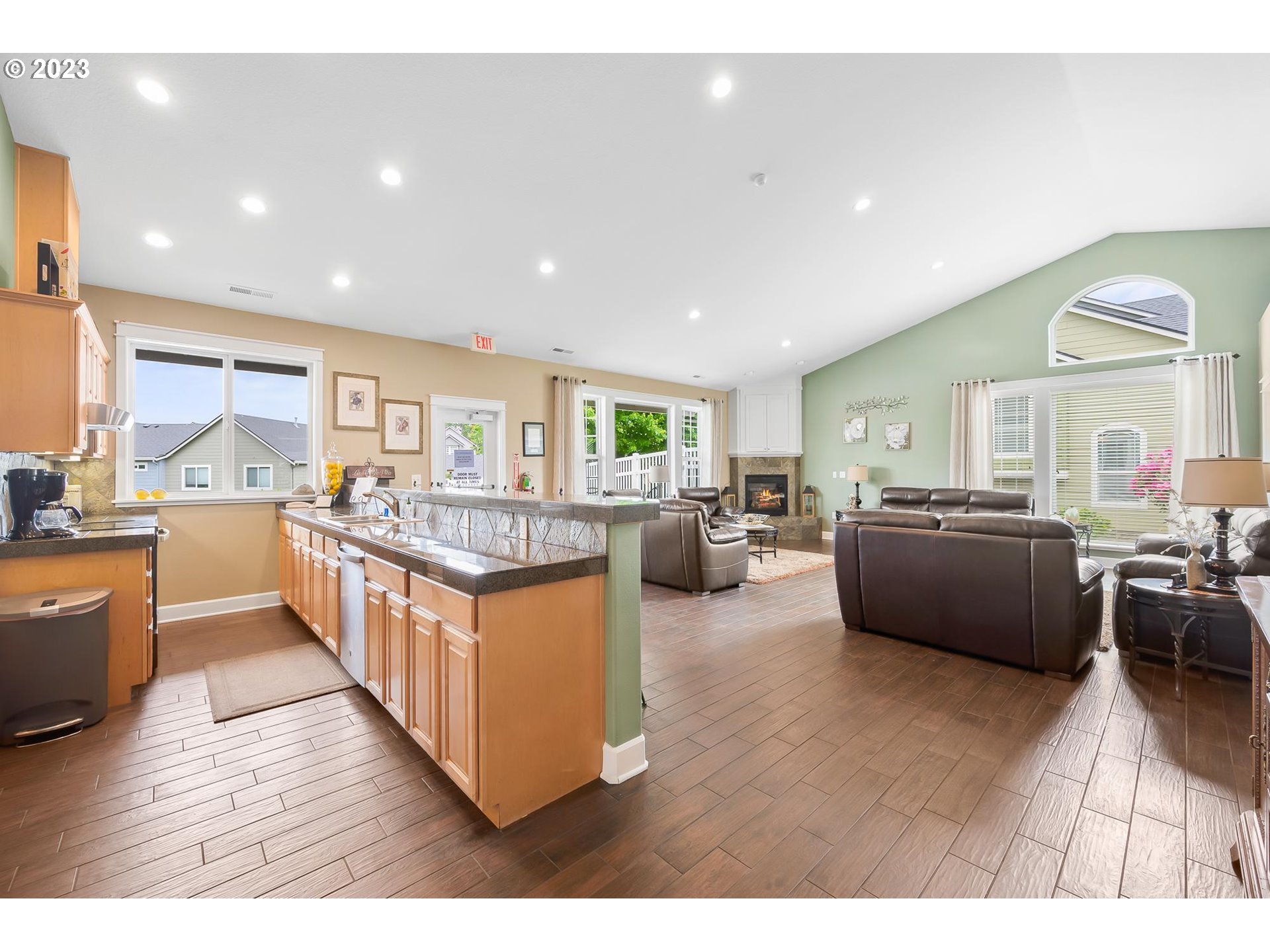2830 Northeast Blossom Hill Road Fairview, OR 97024 - Photo 26 of 34 a open kitchen with stainless steel appliances kitchen island granite countertop a large counter top and a view of living room