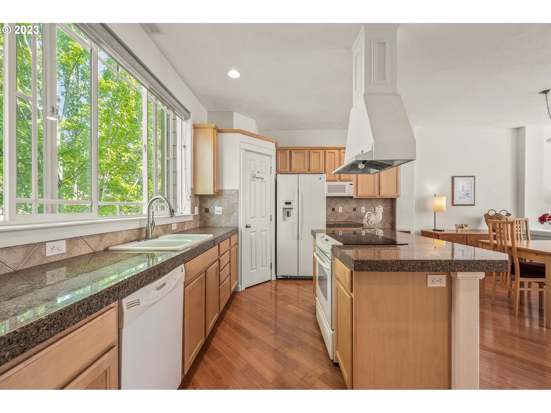 2830 Northeast Blossom Hill Road Fairview, OR 97024 - Photo 8 of 34 a kitchen with stainless steel appliances granite countertop a sink and a large window