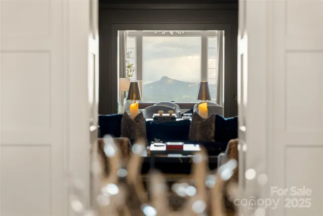 a living room with furniture and floor to ceiling window