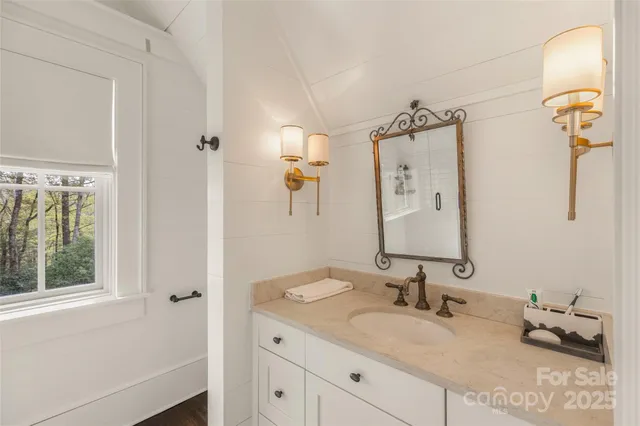 a bathroom with a granite countertop sink mirror and a