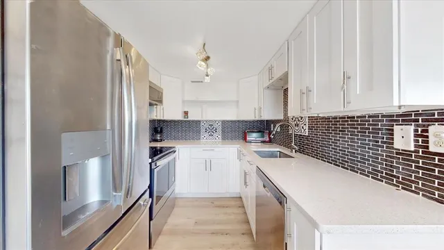 a kitchen with a sink stove and refrigerator