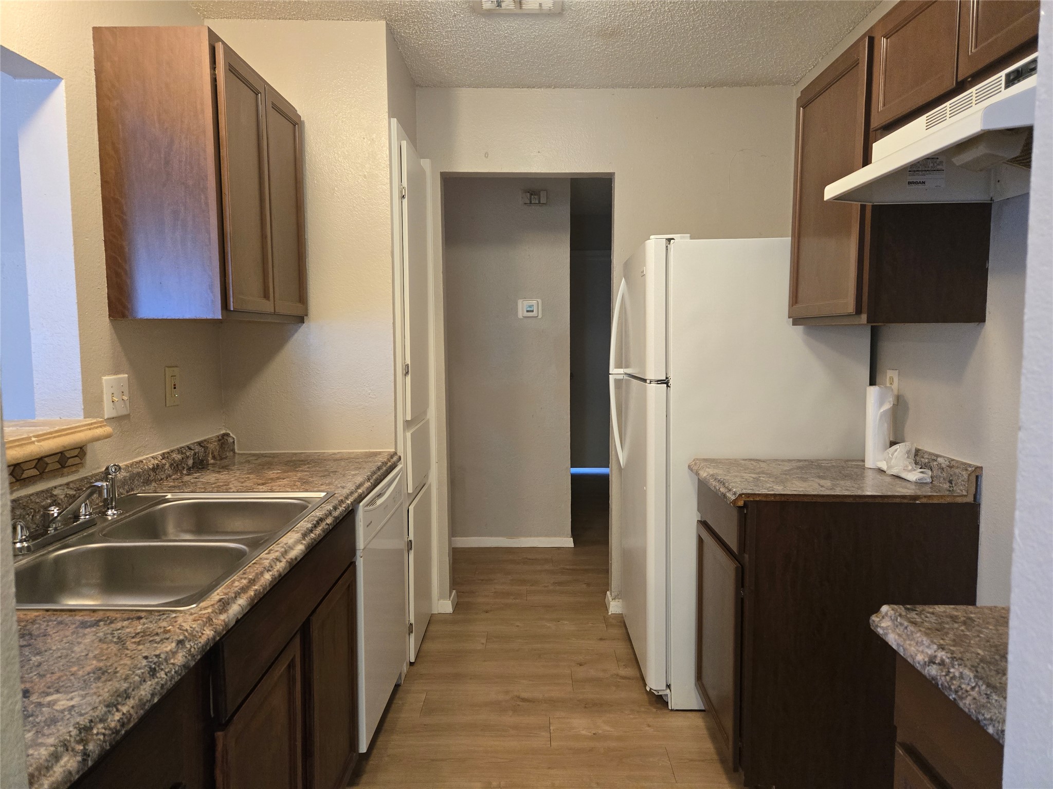 1011 Ridgemont Street Round Rock, TX 78664 - Photo 13 of 14 a kitchen with a sink stove and refrigerator
