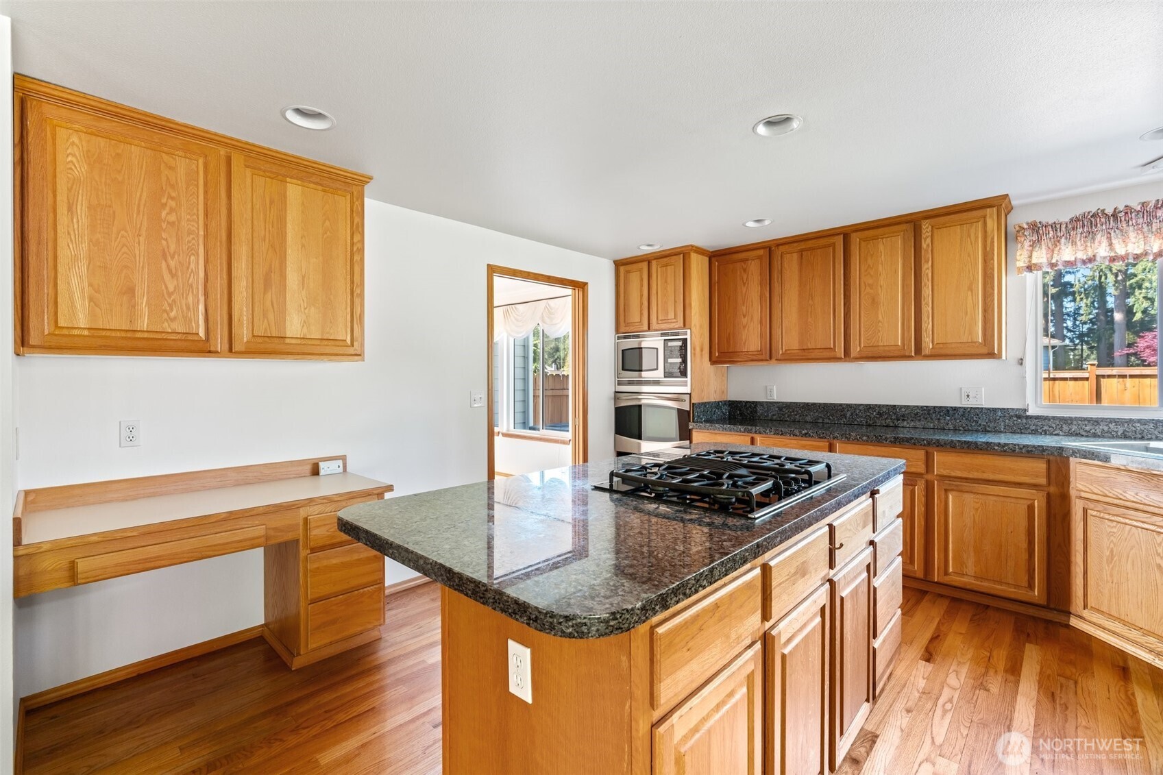 9536 Marlbrook Loop Southeast Olympia, WA 98513 - Photo 21 of 40 a kitchen with granite countertop a sink cabinets and wooden floor