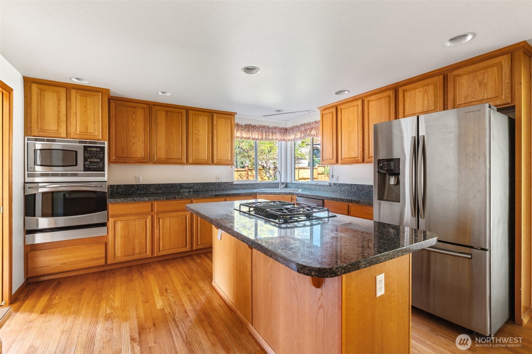 9536 Marlbrook Loop Southeast Olympia, WA 98513 - Photo 23 of 40 a kitchen with stainless steel appliances granite countertop a refrigerator a stove top oven a sink and dishwasher