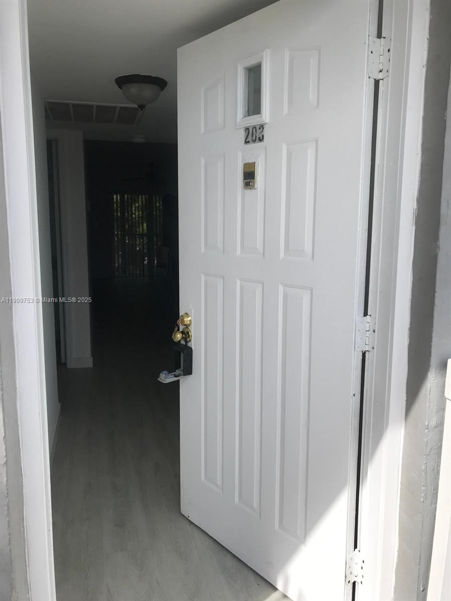 438 Northeast 210th Cir Terrace, Unit 2034B Miami, FL 33179 - Photo 1 of 20 a view of a hallway