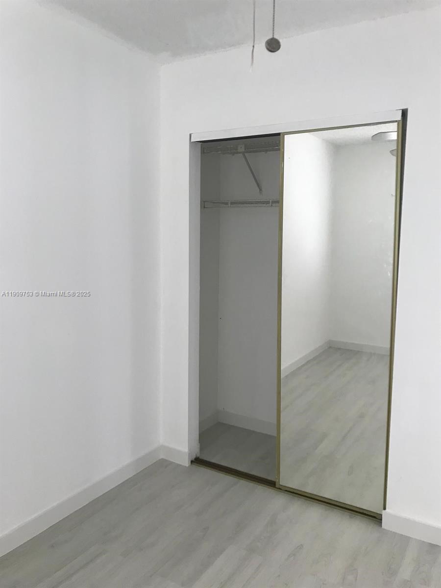 438 Northeast 210th Cir Terrace, Unit 2034B Miami, FL 33179 - Photo 13 of 20 wooden floor in an empty room