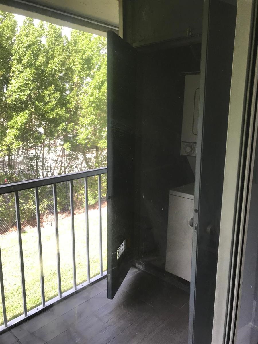 438 Northeast 210th Cir Terrace, Unit 2034B Miami, FL 33179 - Photo 20 of 20 a view of empty room with floor to ceiling window