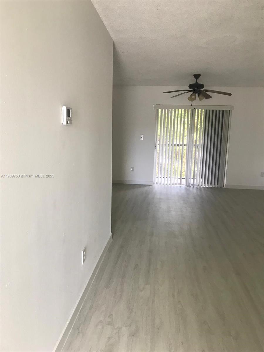 438 Northeast 210th Cir Terrace, Unit 2034B Miami, FL 33179 - Photo 3 of 20 a view of an empty room with a window