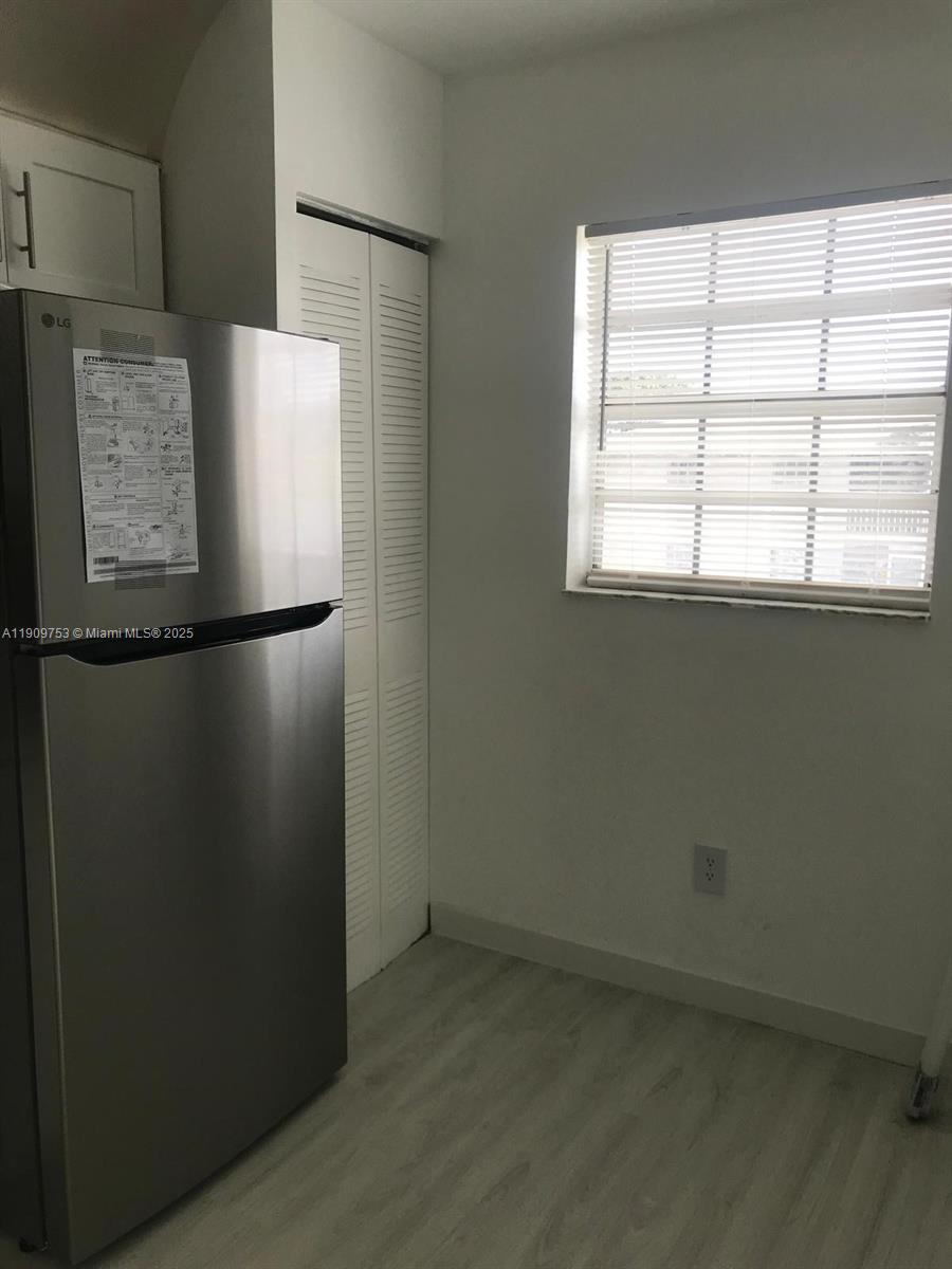 438 Northeast 210th Cir Terrace, Unit 2034B Miami, FL 33179 - Photo 8 of 20 a view of a refrigerator in a kitchen