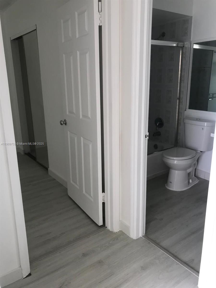 438 Northeast 210th Cir Terrace, Unit 2034B Miami, FL 33179 - Photo 9 of 20 a bathroom with a toilet and a shower