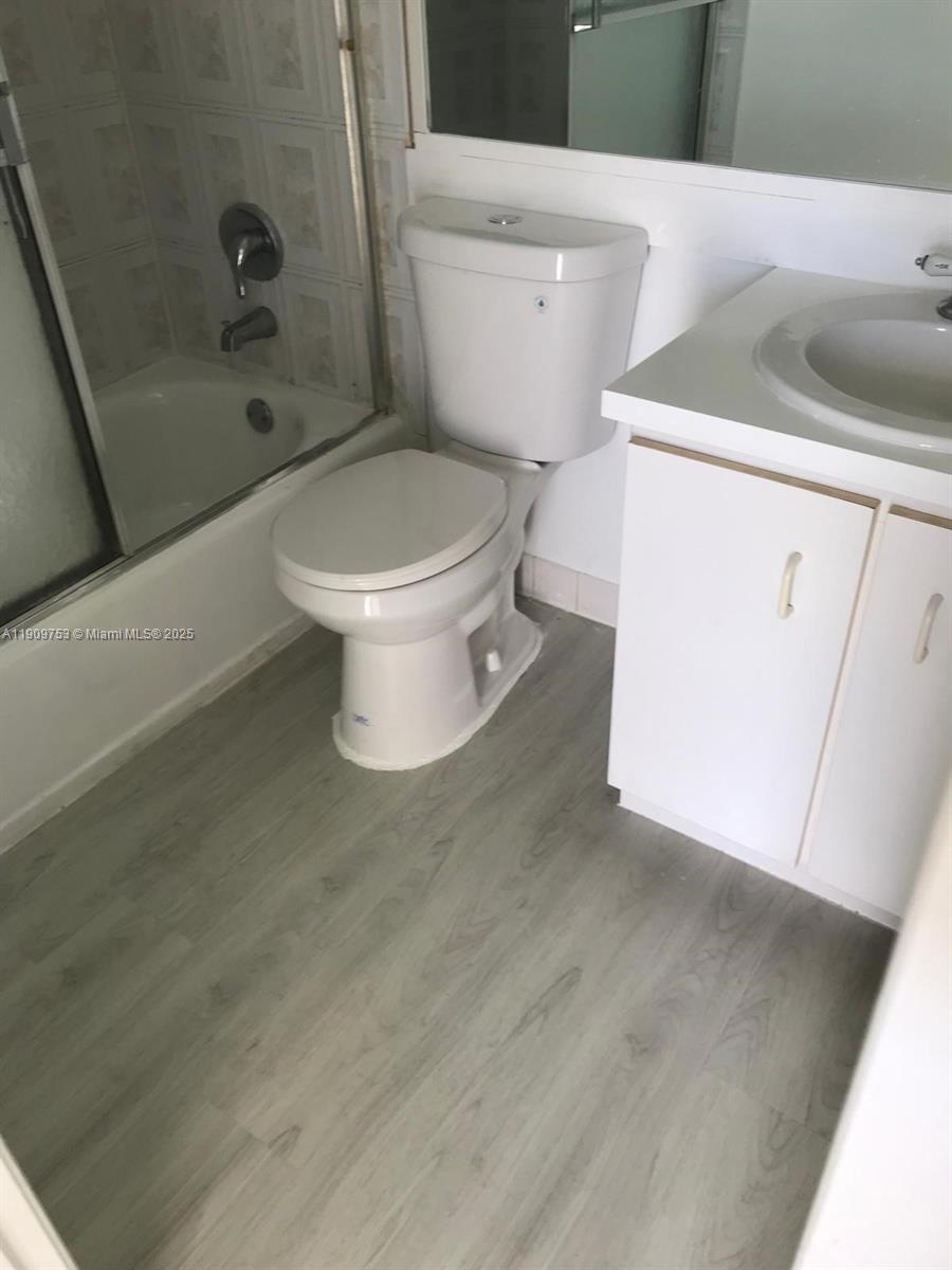 438 Northeast 210th Cir Terrace, Unit 2034B Miami, FL 33179 - Photo 10 of 20 a white toilet sitting next to a bathroom sink