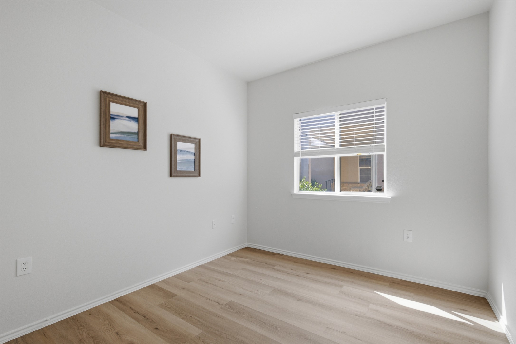 126 Whitewing Way Georgetown, TX 78633 - Photo 18 of 28 Well-lit room with wood plank flooring, ready for personalization.