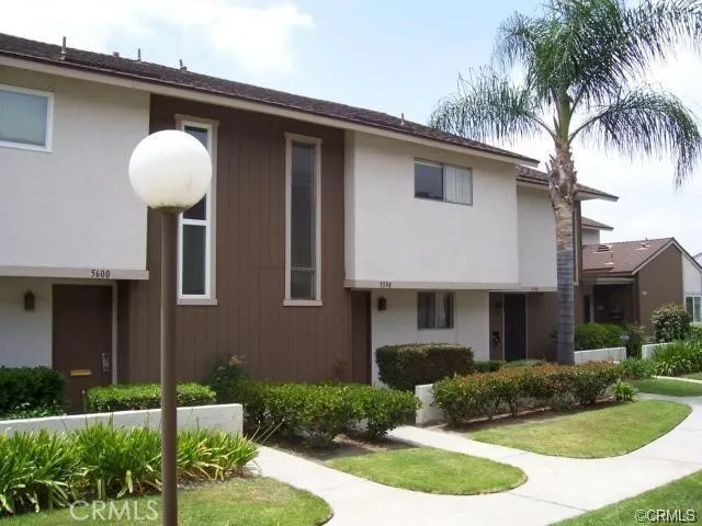 a front view of a house with yard and garage