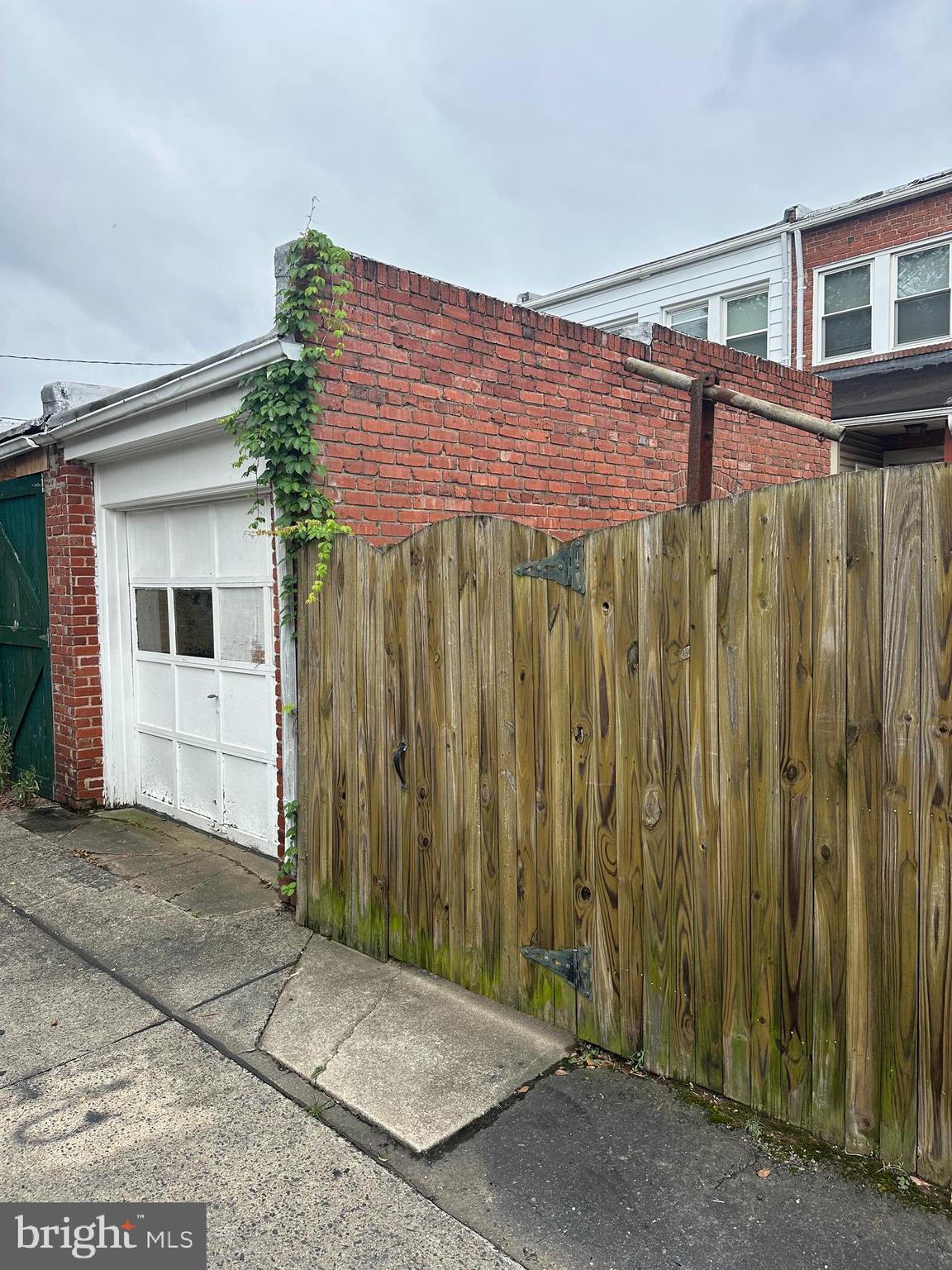 6822 Dunbar Road Baltimore, MD 21222 - Photo 17 of 20 a front view of a house with a wooden fence