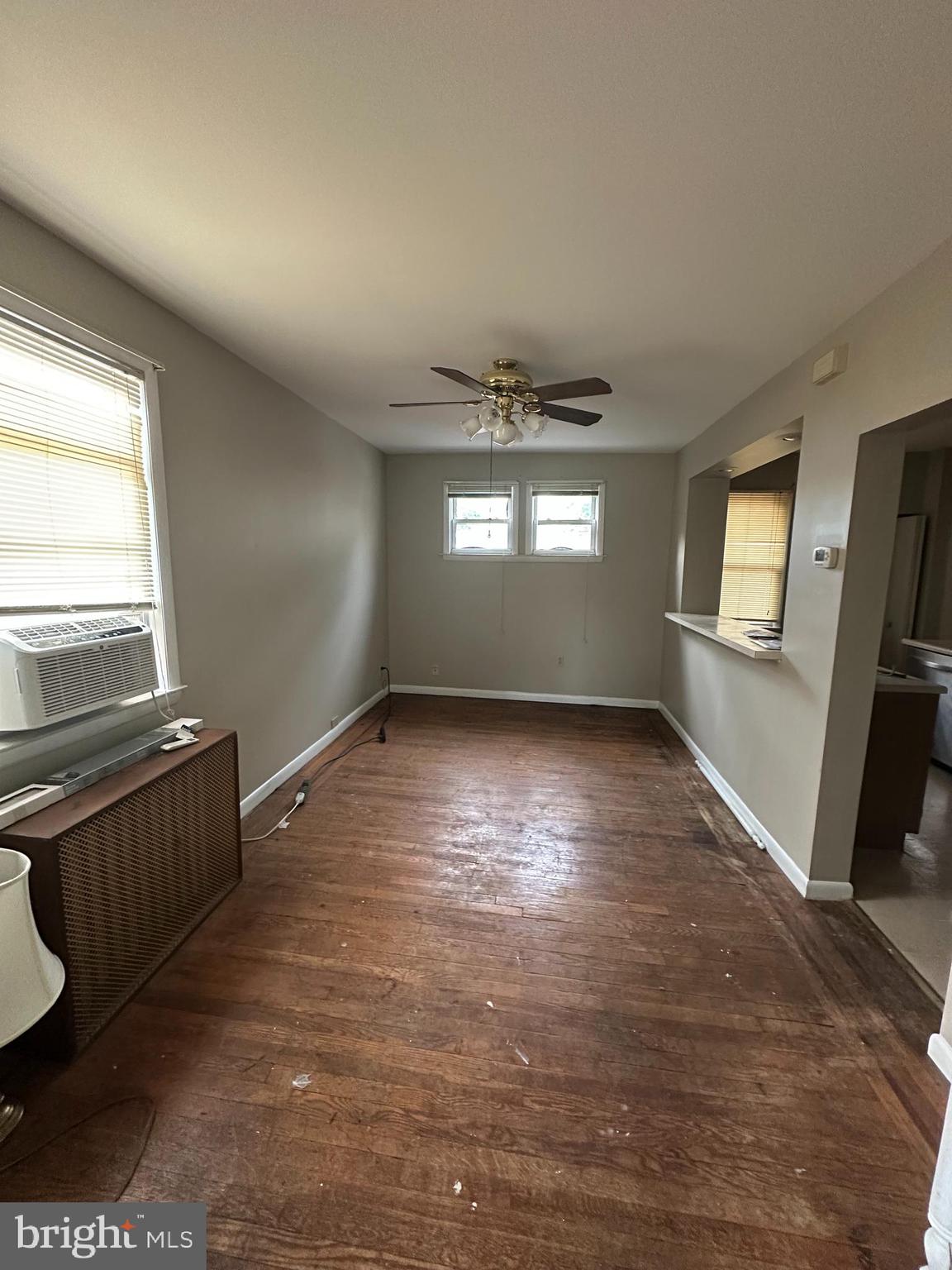 6822 Dunbar Road Baltimore, MD 21222 - Photo 4 of 20 an empty room with wooden floor and windows