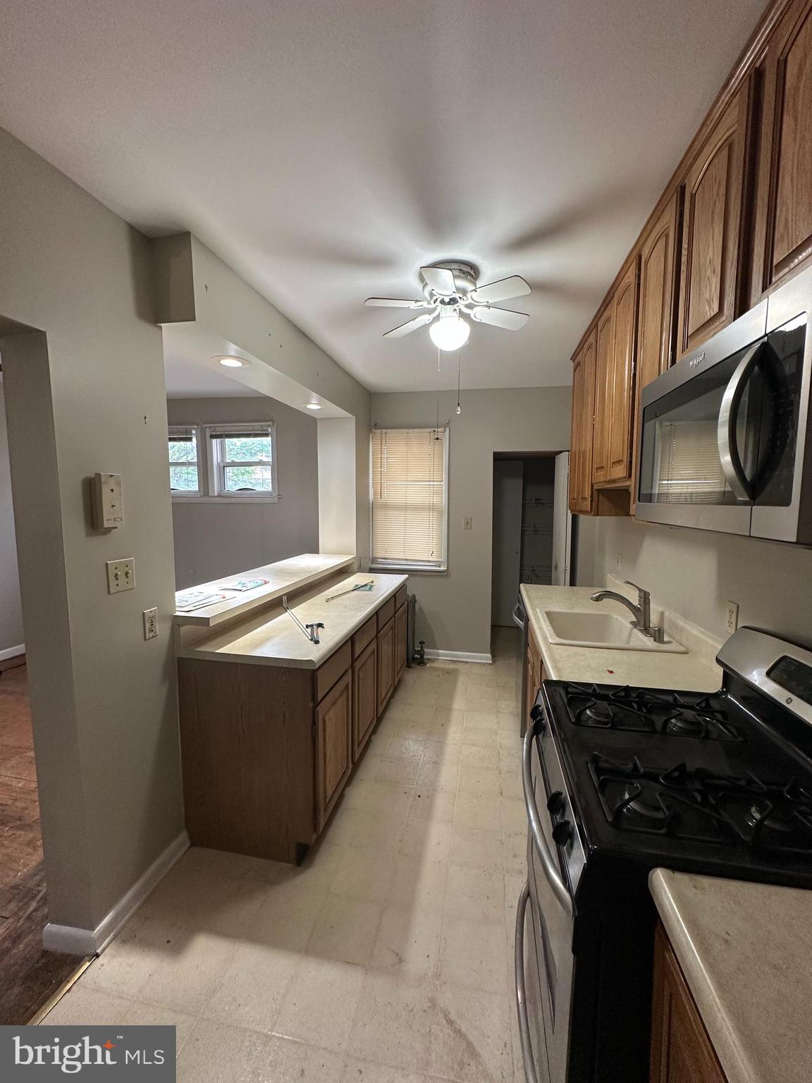6822 Dunbar Road Baltimore, MD 21222 - Photo 5 of 20 a kitchen with stainless steel appliances granite countertop a stove and a sink