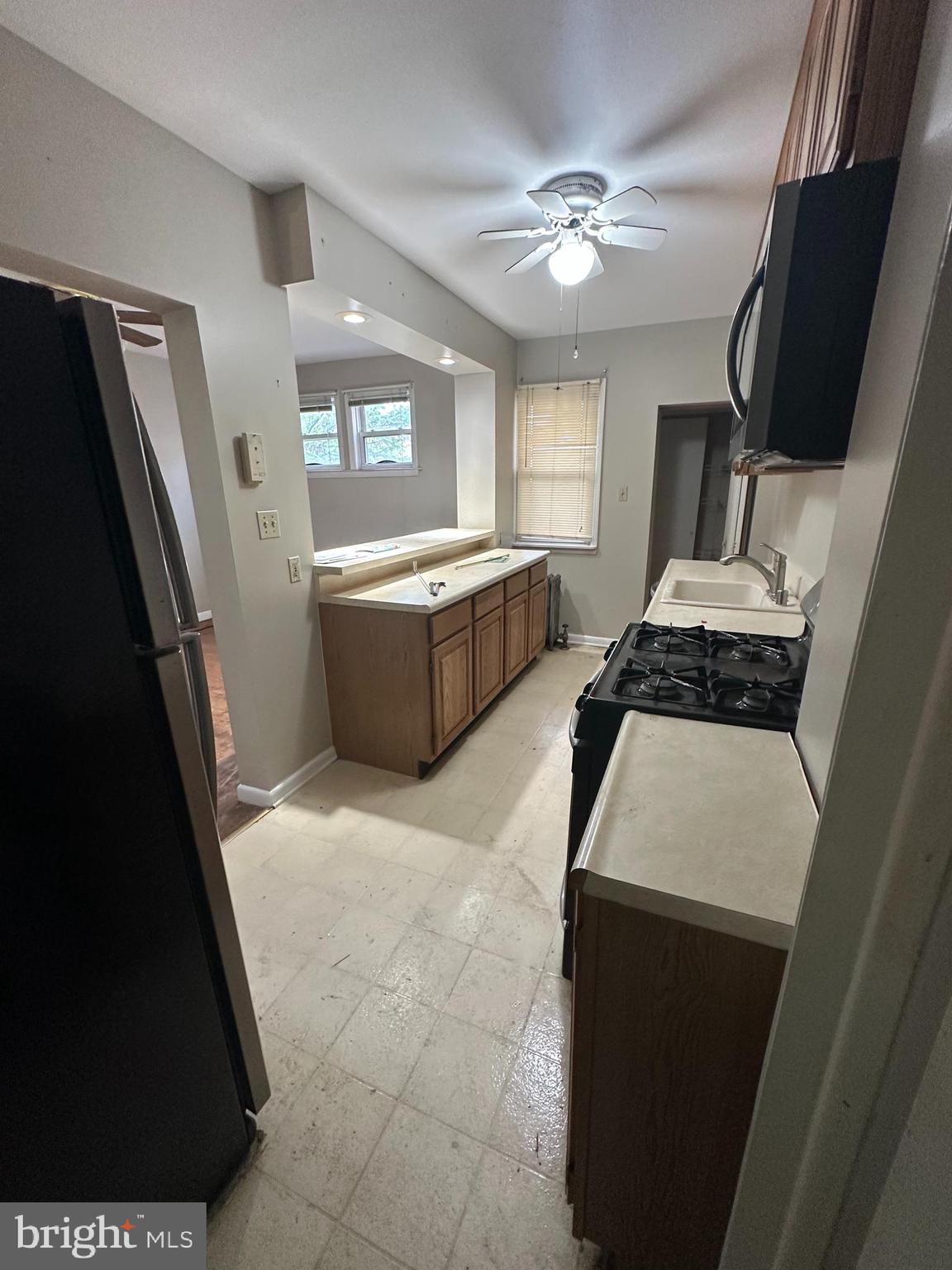 6822 Dunbar Road Baltimore, MD 21222 - Photo 8 of 20 a kitchen with a refrigerator and a sink