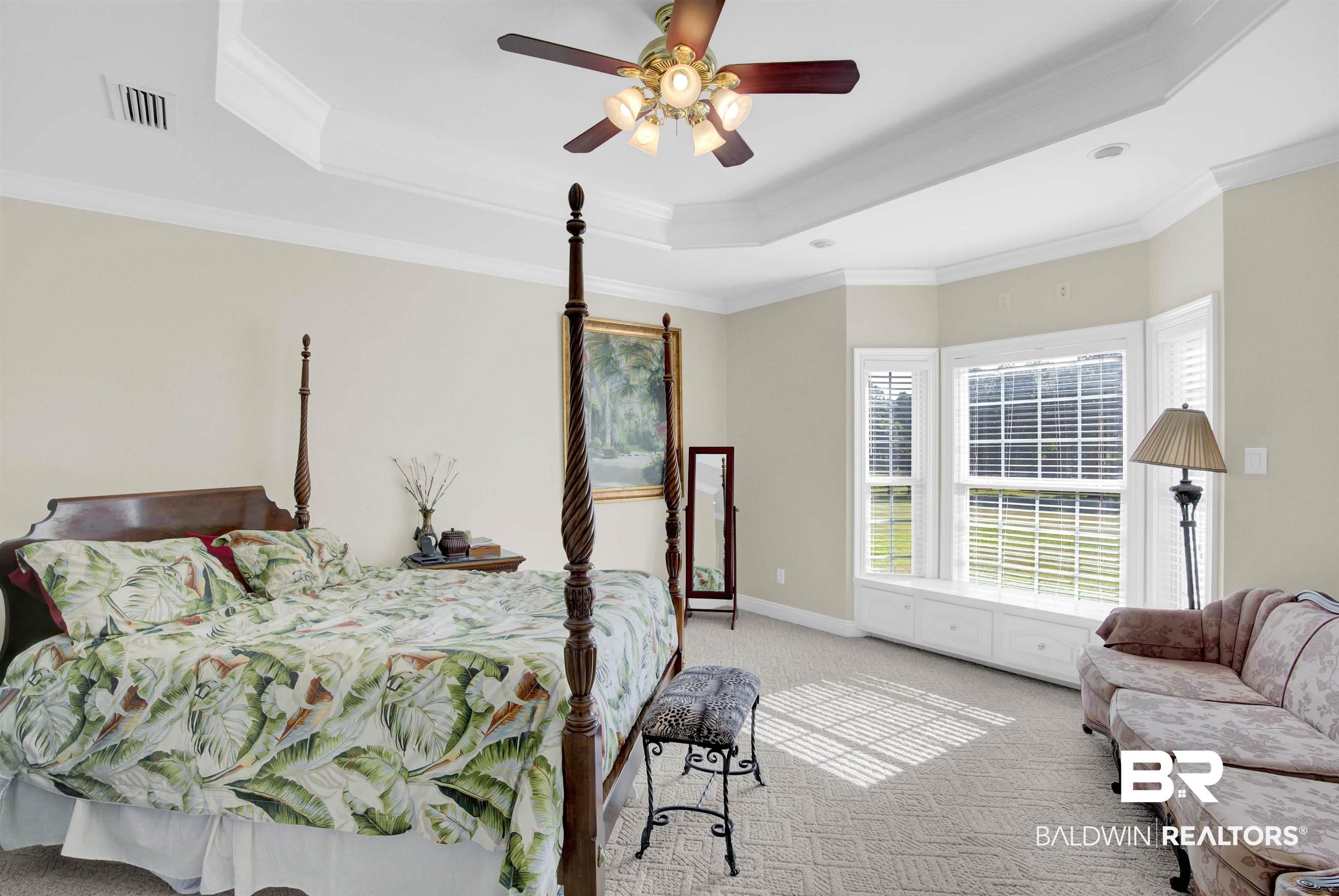 27688 Rigsby Road Daphne, AL 36526 - Photo 27 of 56 Carpeted bedroom featuring ceiling fan, a raised ceiling, and ornamental molding
