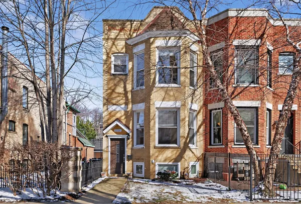 a view of a brick building next to a road