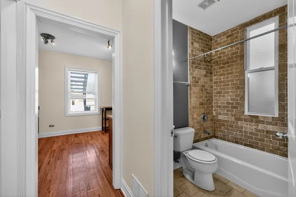 a bathroom with a toilet and a shower