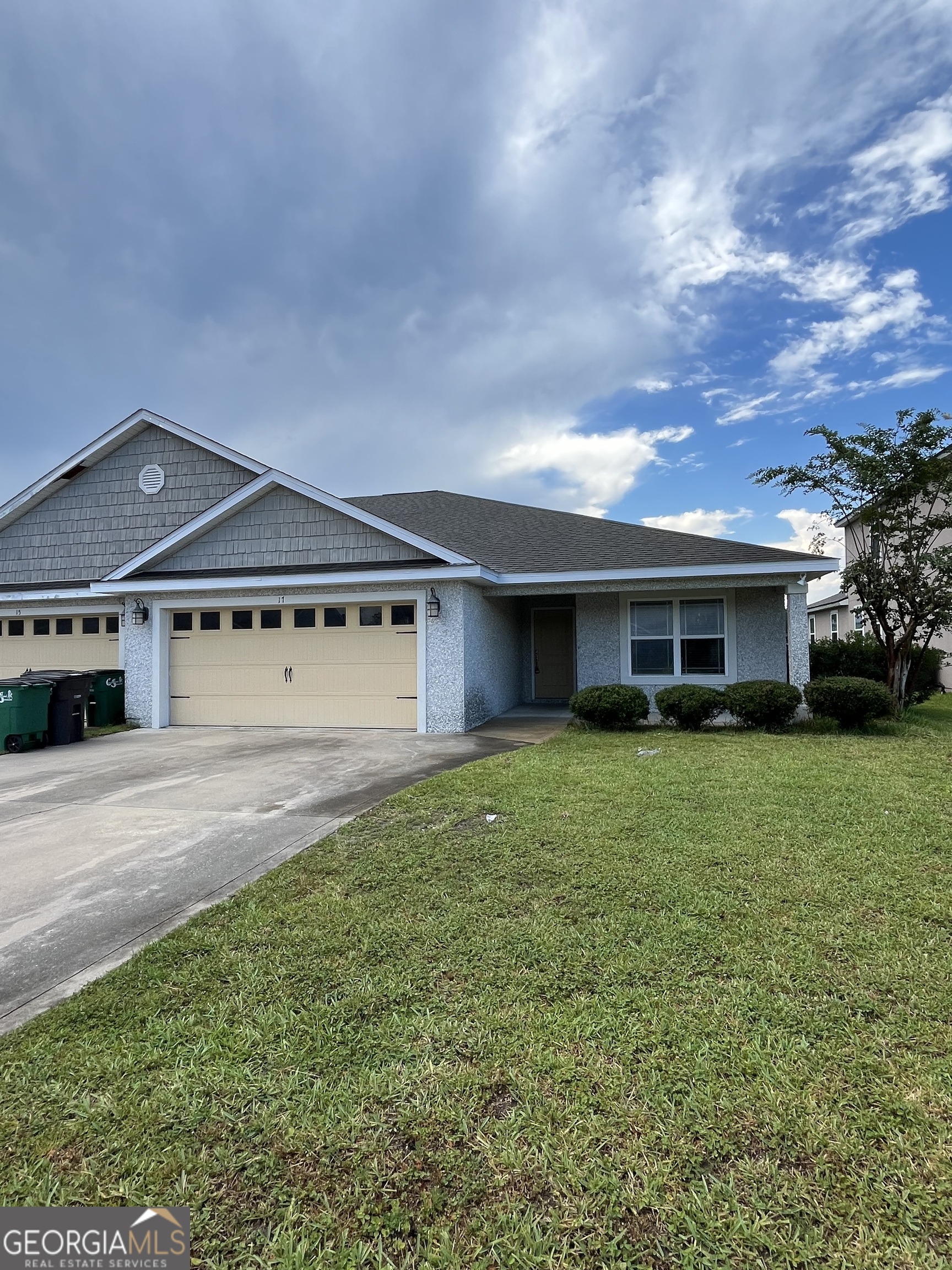 17 Fox Path St. Marys, GA 31558 - Photo 1 of 23 a front view of a house with a yard and garage
