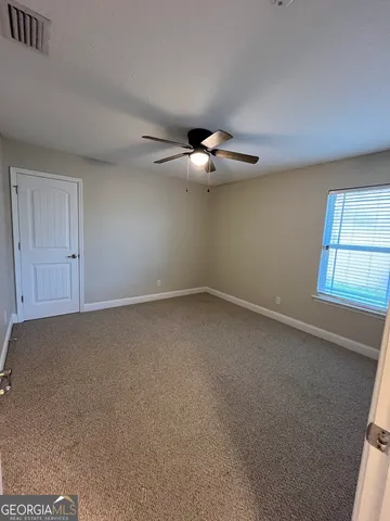 an empty room with a empty space and windows