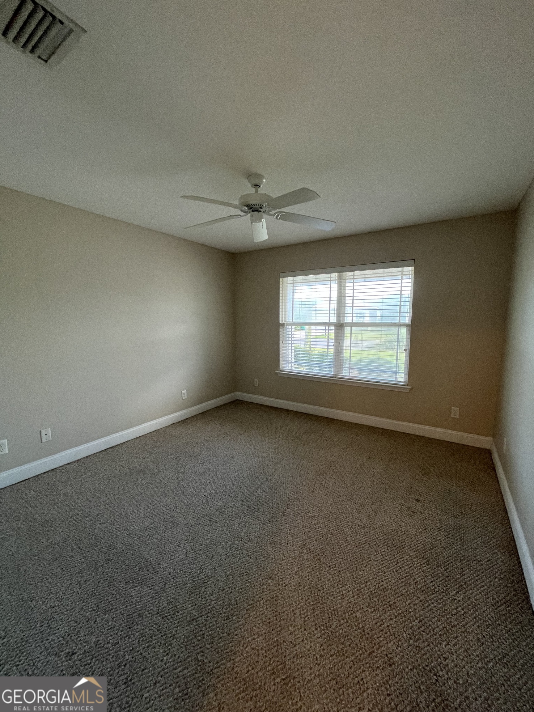 17 Fox Path St. Marys, GA 31558 - Photo 9 of 23 an empty room with a window and a ceiling fan