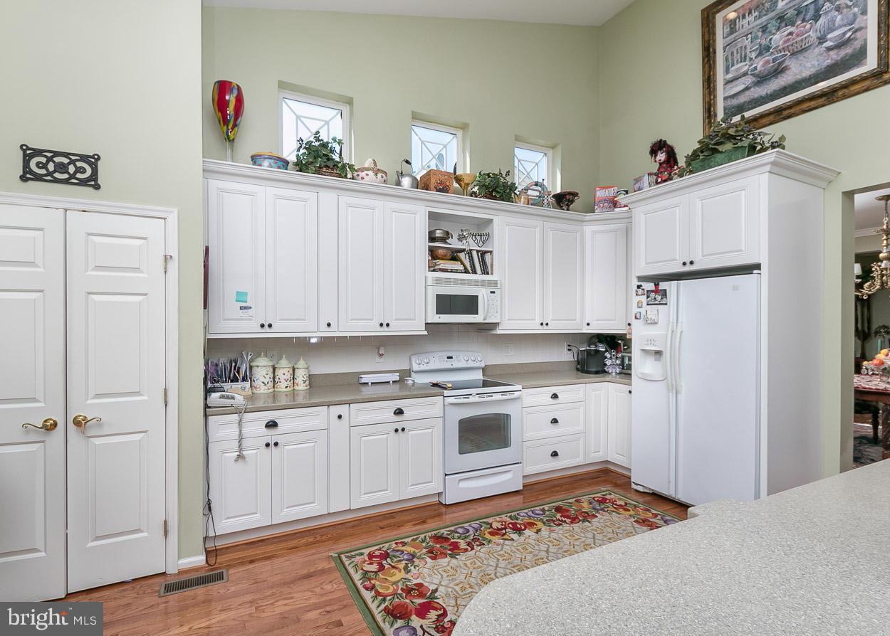 8605 Snowreath Road, Unit 8605 Pikesville, MD 21208 - Photo 3 of 30 Bright Kitchen with wood floors.