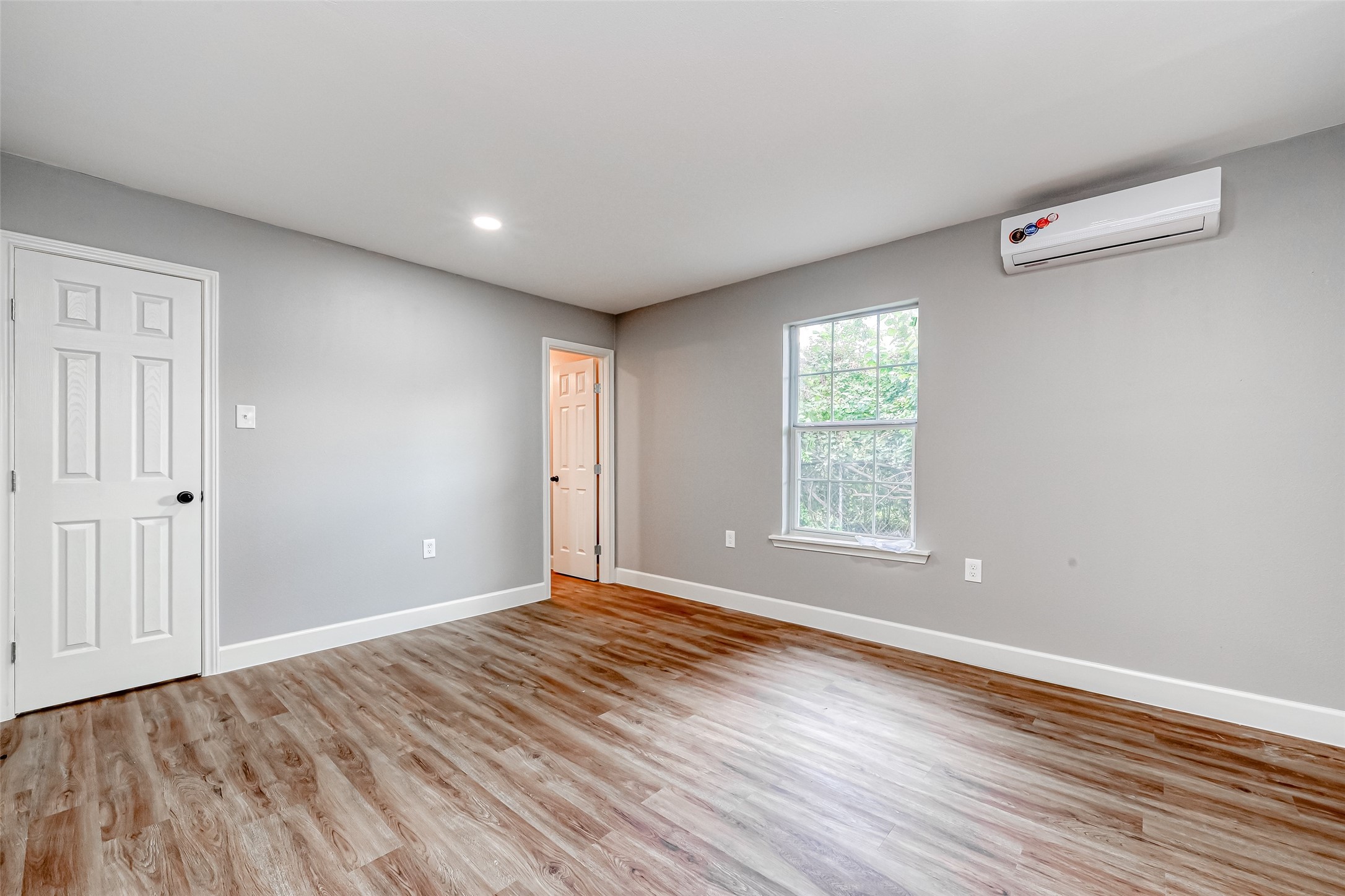 6715 Victoria Street Houston, TX 77020 - Photo 23 of 46 a view of an empty room with wooden floor and a window
