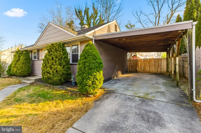 a view of backyard with a table and chair under an umbrella