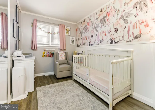 a view of a bedroom with baby crib and couch