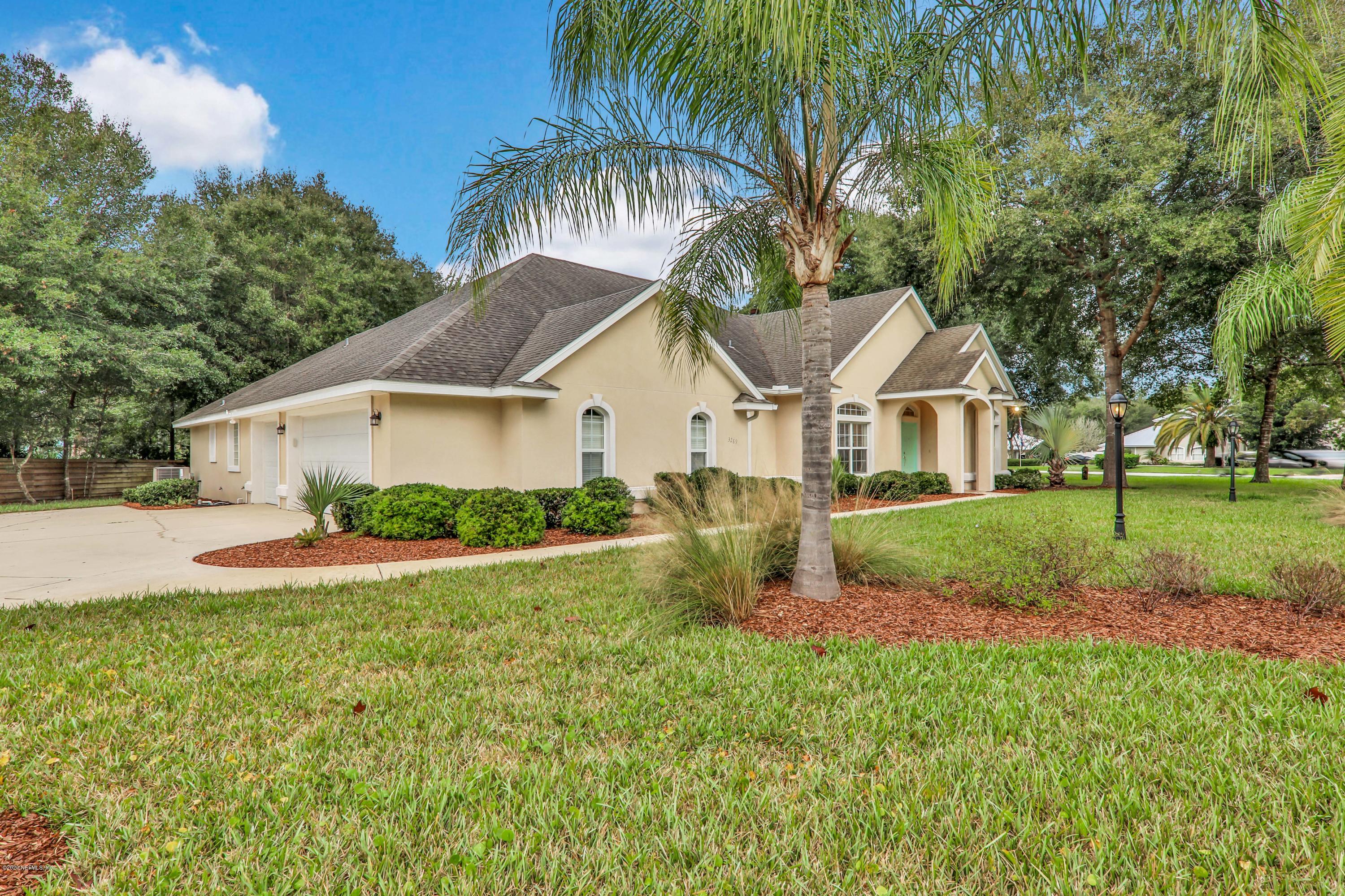 3289 Kings Road South St. Augustine, FL 32086 - Photo 1 of 41 a front view of a house with a yard and garage