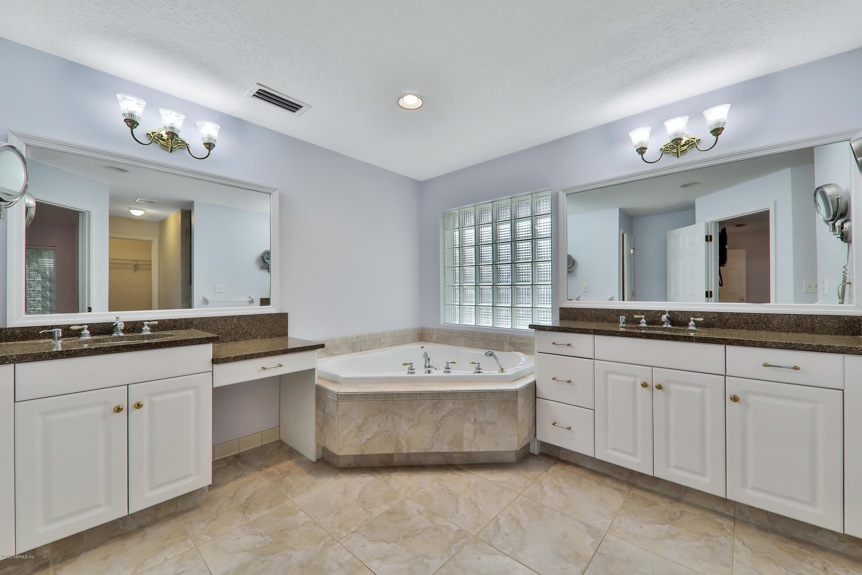 3289 Kings Road South St. Augustine, FL 32086 - Photo 11 of 41 a spacious bathroom with a granite countertop double vanity sink mirror and bathtub