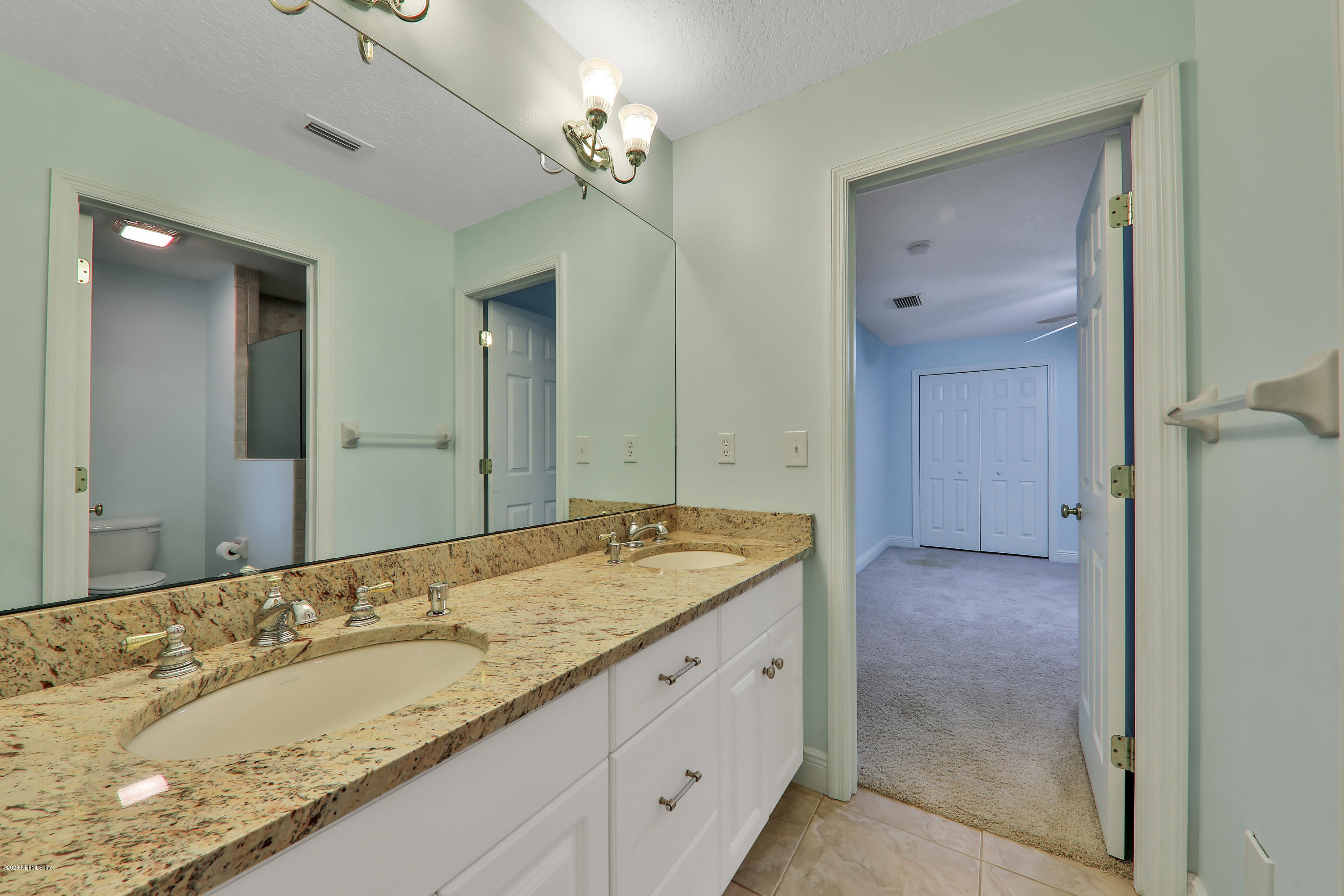3289 Kings Road South St. Augustine, FL 32086 - Photo 13 of 41 a spacious bathroom with a granite countertop sink and a mirror