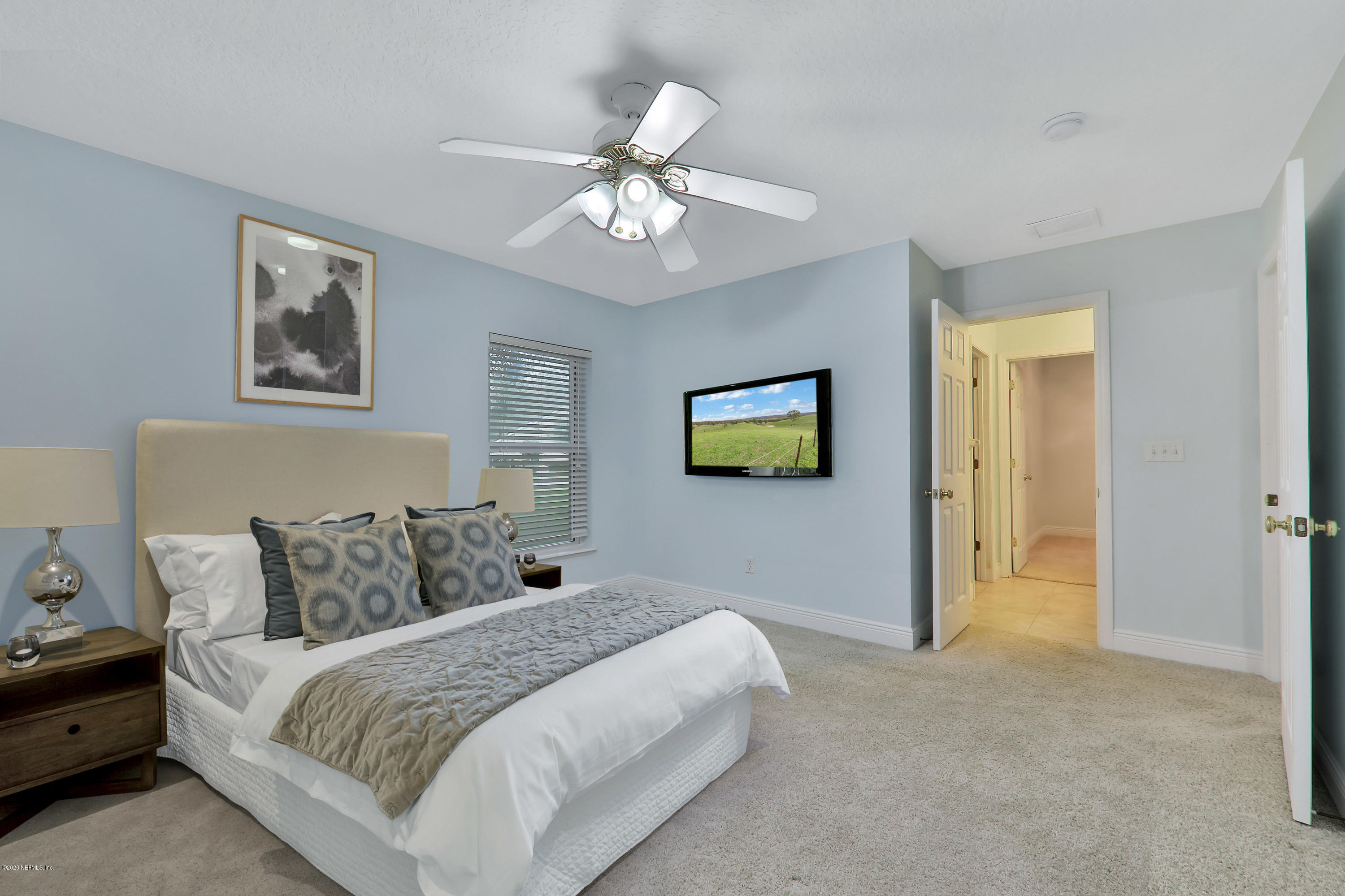 3289 Kings Road South St. Augustine, FL 32086 - Photo 17 of 41 a bedroom with a bed and a chandelier