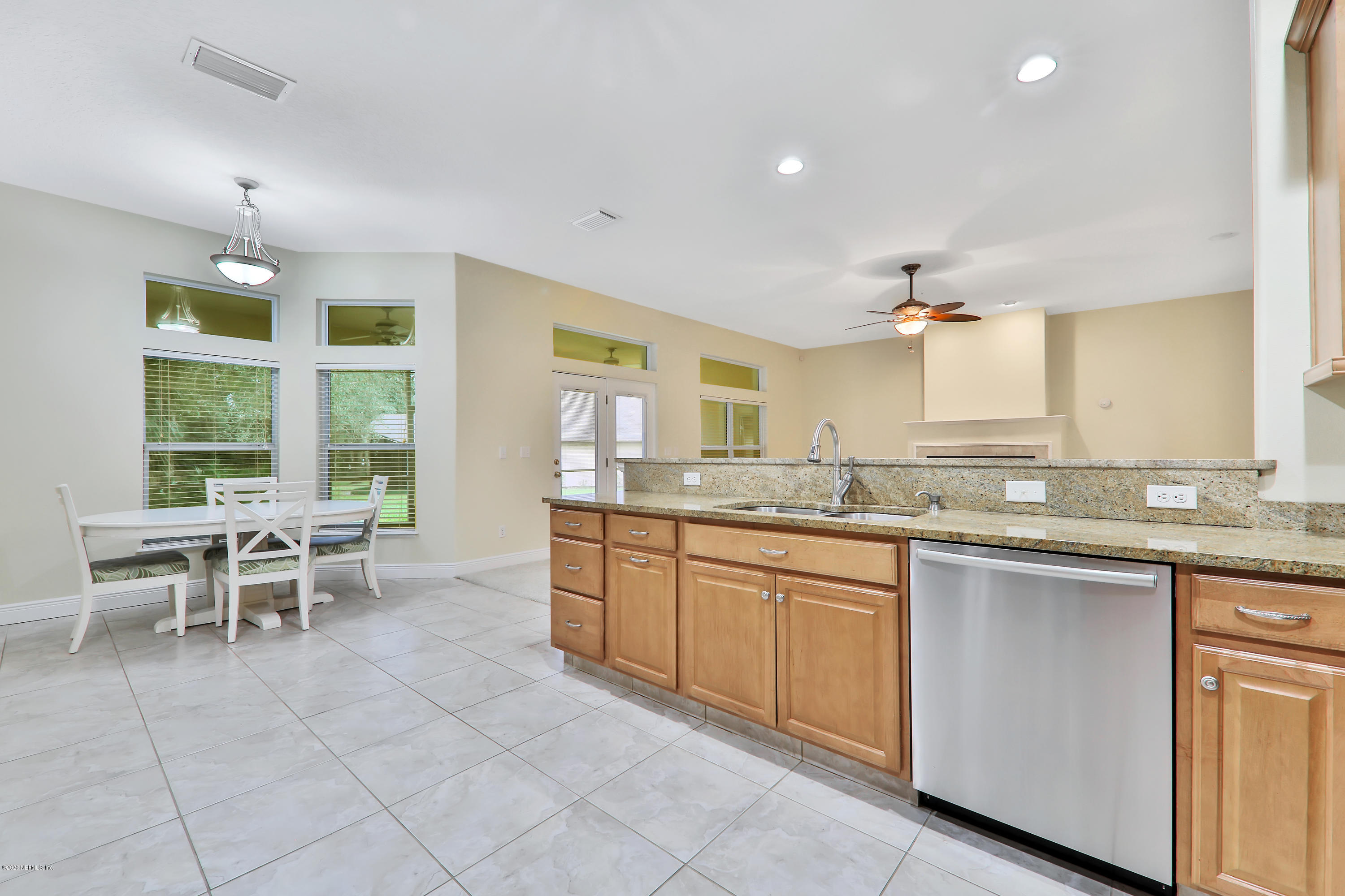 3289 Kings Road South St. Augustine, FL 32086 - Photo 28 of 41 a large kitchen with kitchen island granite countertop a table and chairs in it