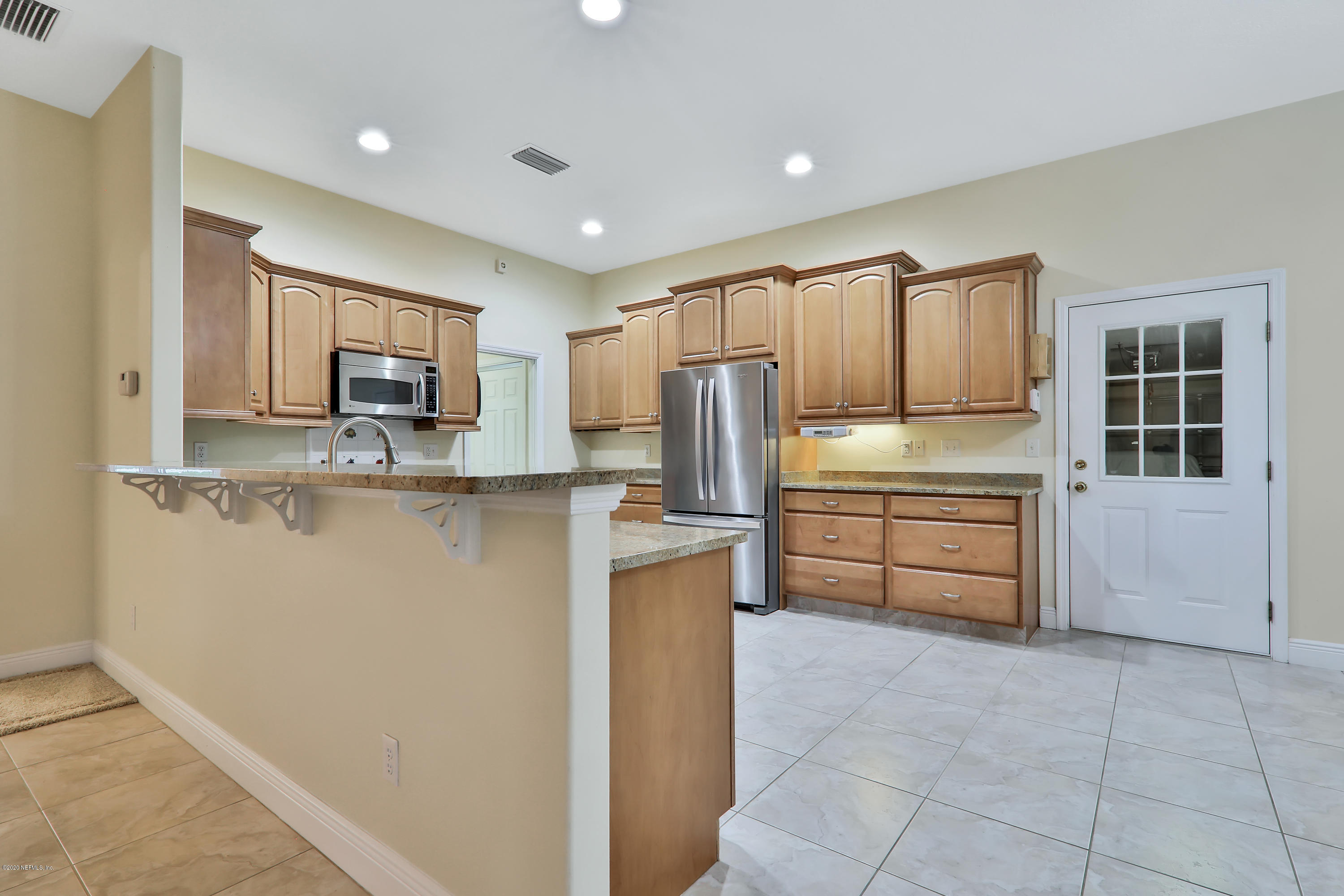 3289 Kings Road South St. Augustine, FL 32086 - Photo 32 of 41 a kitchen with kitchen island a counter top space appliances and cabinets