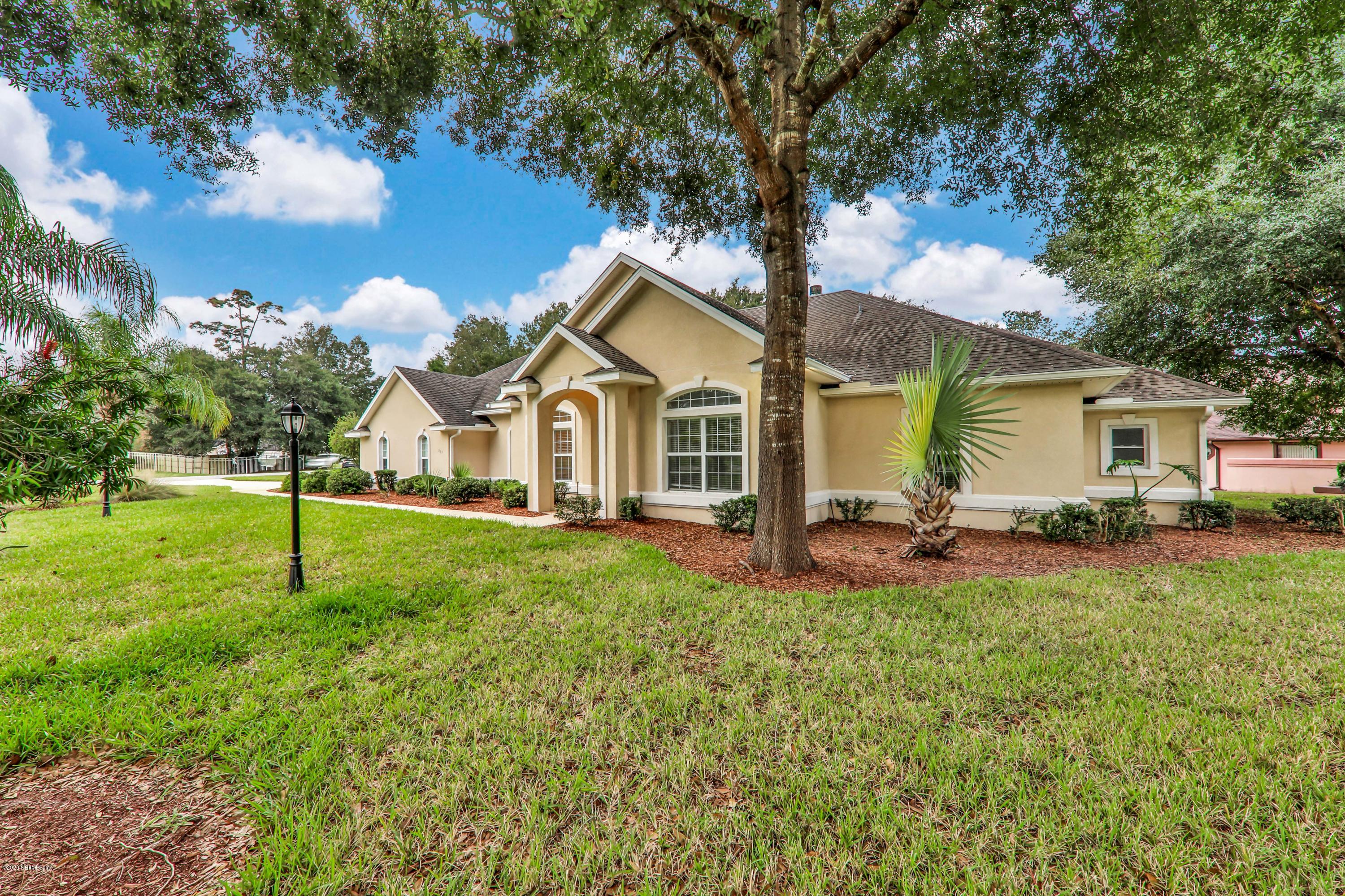 3289 Kings Road South St. Augustine, FL 32086 - Photo 40 of 41 a house view with a garden and trees