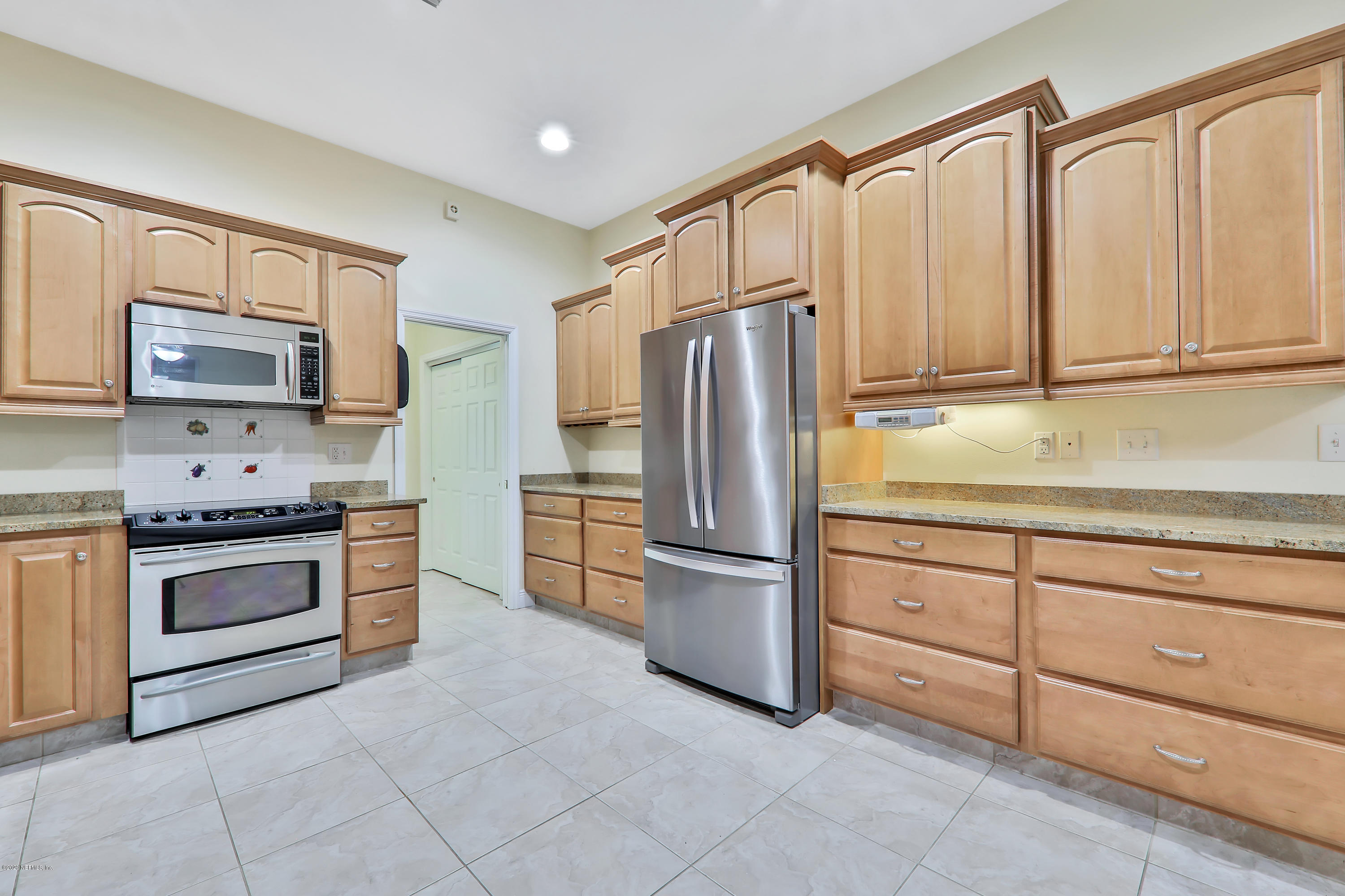 3289 Kings Road South St. Augustine, FL 32086 - Photo 4 of 41 a kitchen with granite countertop a refrigerator stove and sink